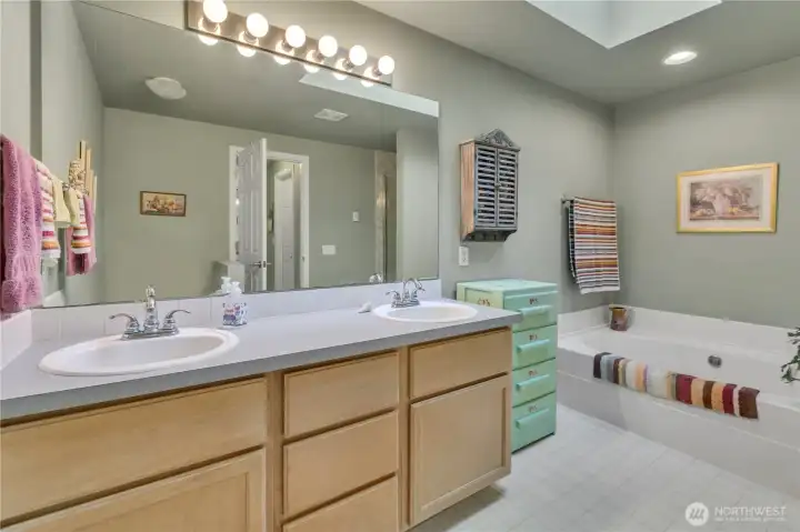 This large bathroom is 5 piece with a separate soaking tub and stand up shower.
