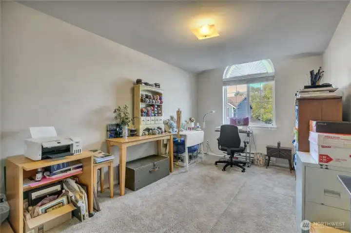 This light and bright bedroom is currently being used as a craft space.