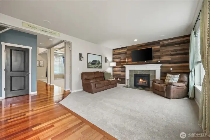 Warm and classy, this natural wood shiplap surrounds the gas fireplace & craftsman-style mantel, making a stunning focal point in the family room.  Corner corbels seen over the closet door are just one of the many stylish touches in this home!