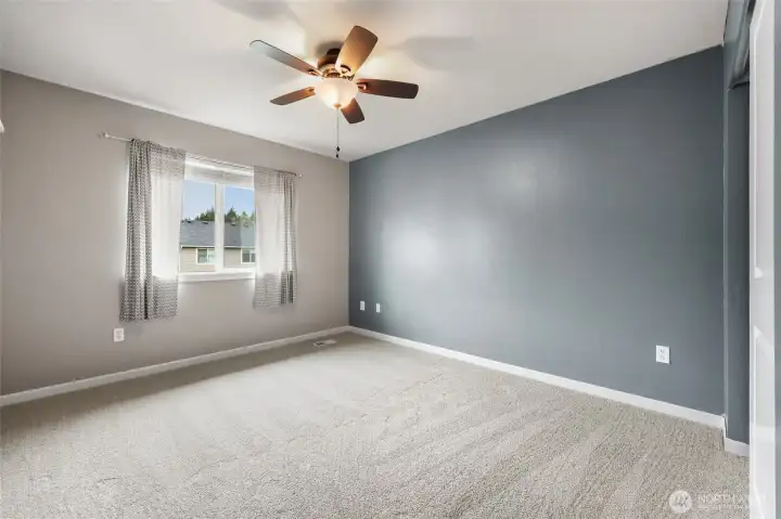 Bedroom #2, with ceiling fan and accent wall.