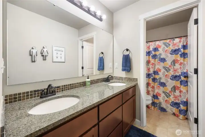 Hall bath has smart design with double vanity and separate shower/commode, for easy sharing when necessary!