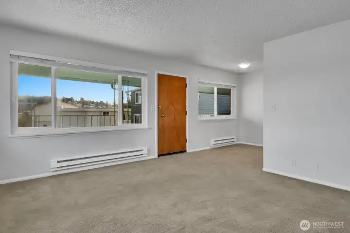 Living and dining area showing inside of front door.