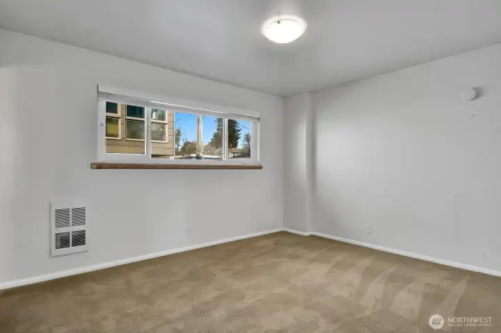 Bedroom with electric wall heater.  Tenants pay for their own electric.