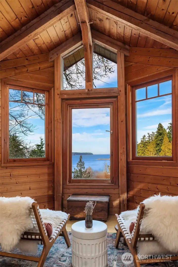 Seating area in bedroom. Lofted ceilings and high windows make this space feel so spacious and peaceful.