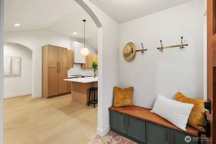 Arched Entryway with terracotta tile & built in bench with storage