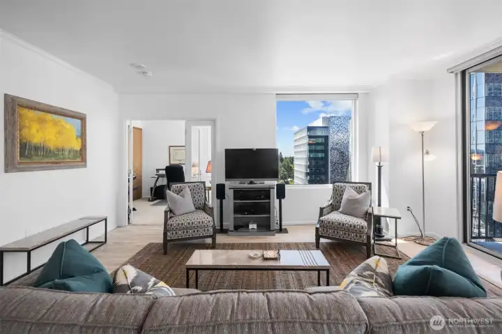 Open-concept living and dining area with hardwood flooring and skyline exposure.