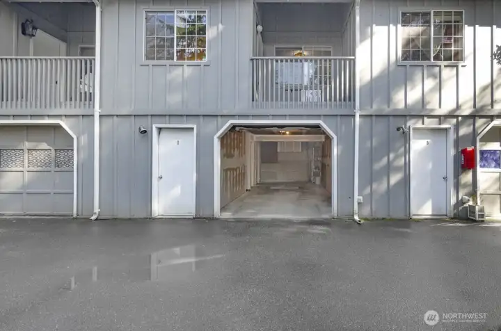 View of the back of the unit. Door to the left offers additional storage. There is additional storage space towards the back of the garage. Room for all your hobbies.