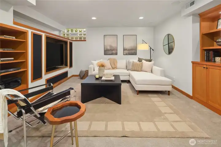 Bonus room downstairs with media center, built-ins, and wood-burning fireplace.