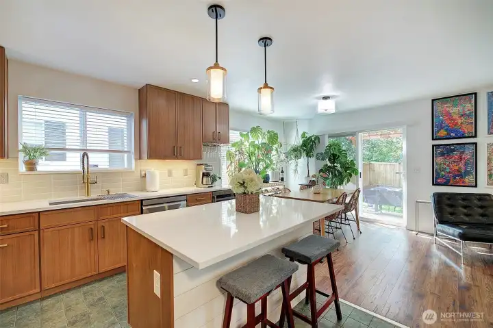 Custom kitchen island has electrical outlets and eating space