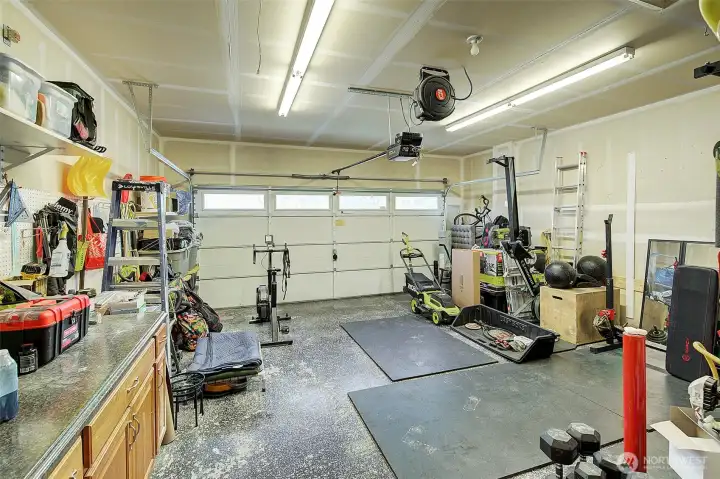 Oversized attached 2 car garage has sparkling epoxy floors