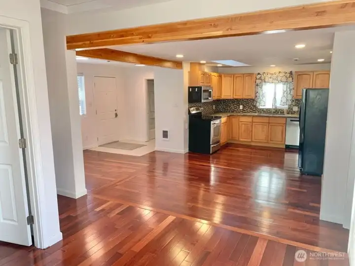 Upper unit A's open floorplan featuring Brazilian cherry hardwood floors and beautiful beams.