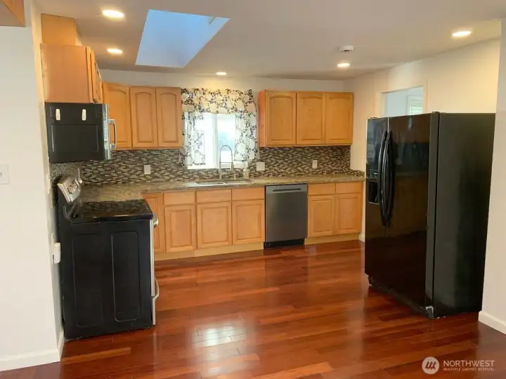 Kitchen maple cabinets, tile backsplash, dishwasher & skylight. Upgraded venting upstairs with proper ducting.