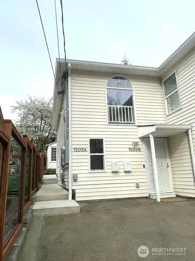 Entrance to 1505A up the re-built side walkway & retaining wall, added integrated drainage system to wall, & new trellis fence. Unit B entrance with 2 car parking right outside door. Both units have an elecrtric car charge.