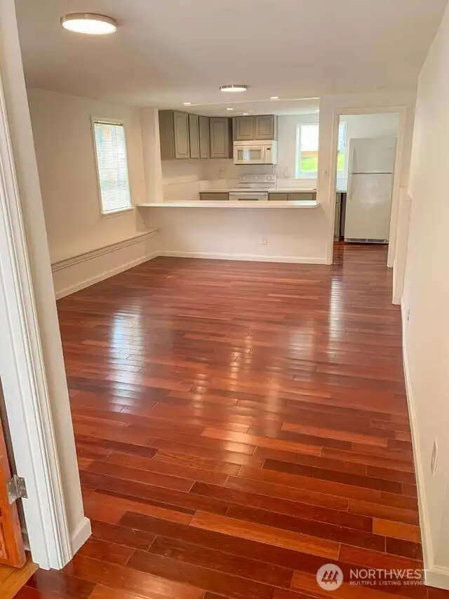 Unit B: Seller opened up wall to join the kitchen & living/dining space creating flexible layout.