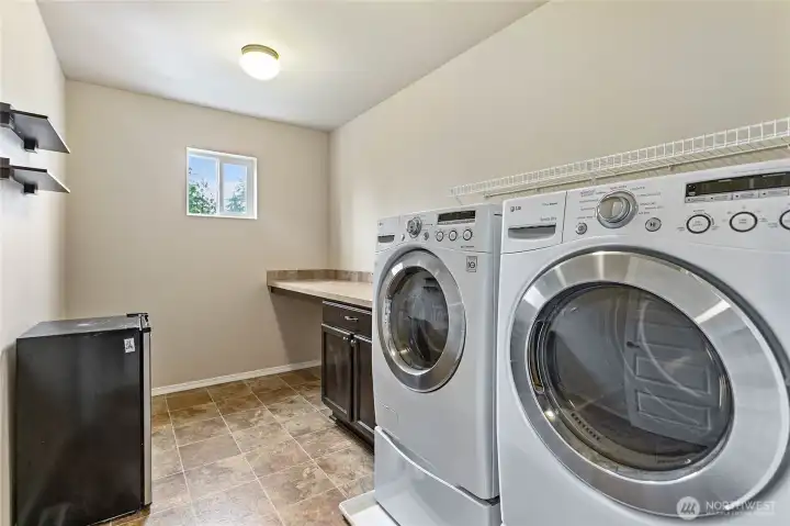 Laundry and utility room with counter space and cabinetry for storage Laundry and utility room with counter space and cabinetry for storage