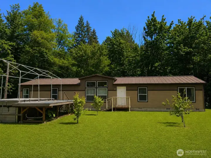Enjoy the beauty of wide-open outdoor space with a large, level lawn surrounded by mature trees and natural landscaping. This peaceful setting offers plenty of room for recreation, gardening, pets, gatherings, or future improvements while providing the privacy and serenity of country living. The expansive yard showcases the property's usable space and inviting outdoor lifestyle, creating the perfect backdrop for relaxing and enjoying the outdoors year-round.