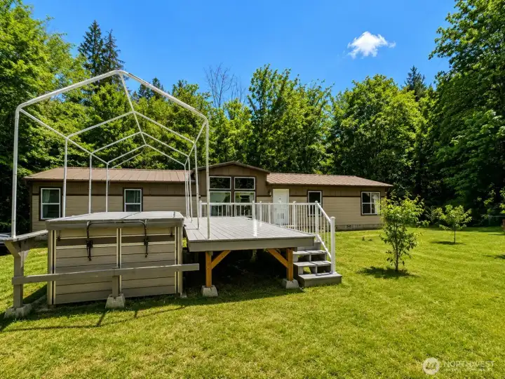 Private and peaceful country setting with versatile outbuildings and plenty of usable space. This well-maintained property features a large barn-style storage shed with wide double doors, ideal for equipment, tools, workshop space, hobbies, or recreational storage. Surrounded by mature trees and open lawn areas, the property offers a serene rural atmosphere with room to garden, entertain, or expand outdoor living. Additional covered storage structures provide even more flexibility for vehicles, projects, or seasonal equipment. Enjoy the beauty of the natural setting, sunny open spaces, and the privacy of a tucked-away homesite while still having functional improvements already in place.