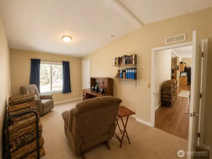 This versatile room offers endless possibilities with its spacious layout, large picture window, and peaceful views of the surrounding property. Whether used as a home office, library, hobby room, guest space, or cozy sitting area, the room provides a quiet and comfortable setting with abundant natural light and convenient access to the main living areas. A perfect flex space to adapt to your lifestyle needs.