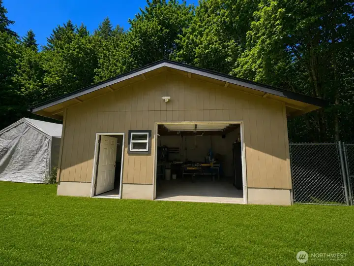Exceptional detached workshop designed for productivity and organization. This spacious building features extensive workbench areas, built-in shelving, ample storage, overhead lighting, and room for tools, equipment, and specialized projects. Large windows provide natural light, while the open floor plan offers flexibility for woodworking, mechanical work, crafts, or home-based business use. A valuable addition to the property, providing dedicated workspace and storage separate from the main residence.