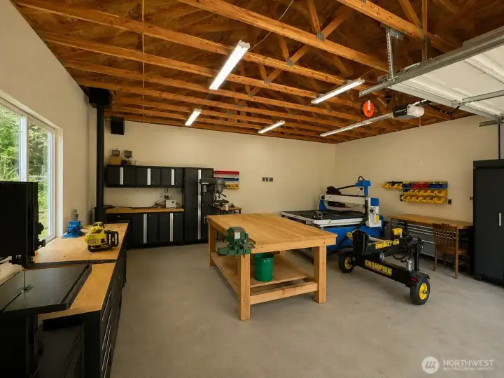 Additional outbuilding and covered storage area provide valuable space for equipment, tools, trailers, firewood, and outdoor supplies. Nestled among mature trees, this versatile section of the property offers functional storage solutions while maintaining the privacy and natural beauty of the setting. Ideal for hobbyists, contractors, outdoor enthusiasts, or anyone needing extra room for equipment and recreational gear.