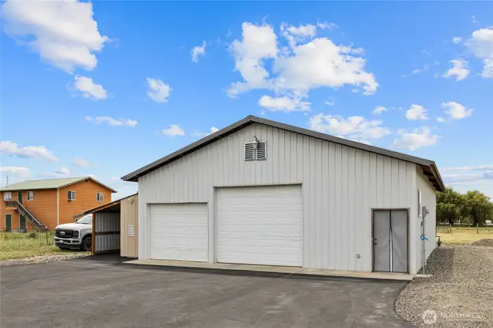 A photo of the large shop just across from the home. It is asphalt, not gravel, what a nice upgrade.
