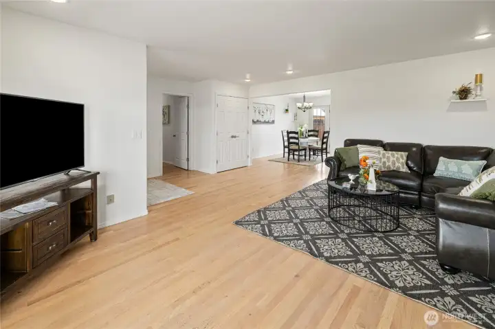 View of the living room into the dining room. Hall way is the entrance to bedrooms, laundry room and bathrooms.