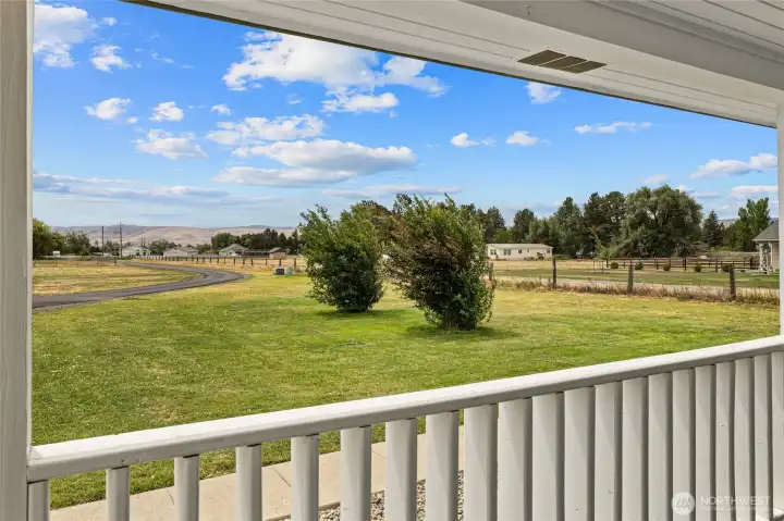 View of the front porch looking out towards the front of the home. What a great place to have morning coffee and looking out on your beautiful property.