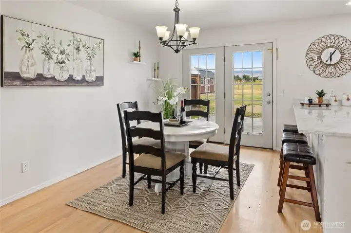 Large dining room with glass French doors opening to the back yard patio.