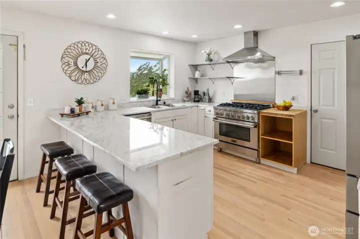 Check out this kitchen! Beautiful quartz counters, lots of natural light and upgraded appliances! What chef wouldn't want to prepare meals in this kitchen.