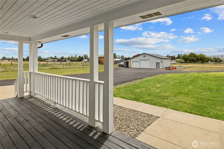 A view of the front porch looking out the front of the home and the massive shop.