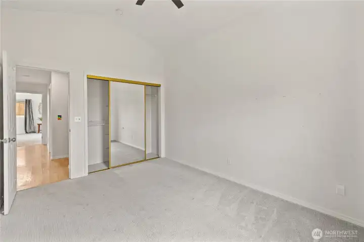 A view of one of the 3 bedrooms, with nice glass closet doors and closet systems installed
