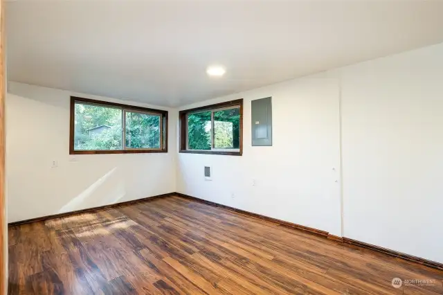 The living room enjoys two large windows and easy to care for flooring.