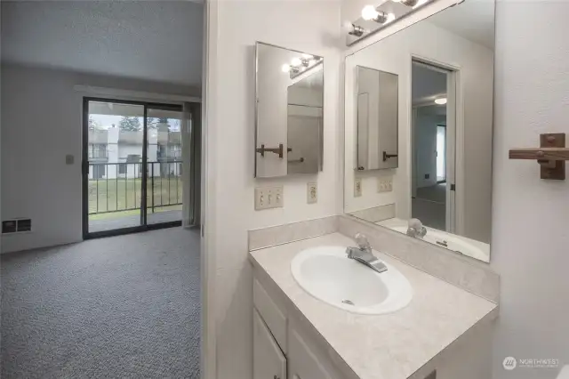 Upstairs full bath has door into bedroom 1 and into the hallway.