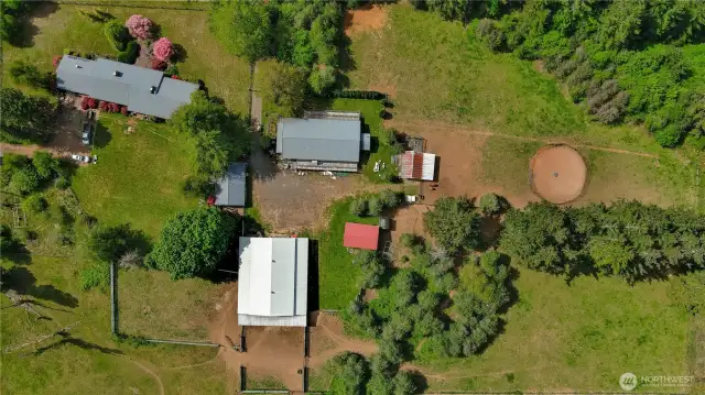 115 Kakela Rd Winlock. Aerial photo shows home, DADU + Kennel, barn, Shed /pump house, additional shed by bullpen, RV parking /carport