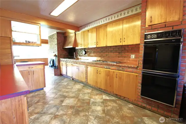 Custom kitchen with copper vent, countertops and double ovens