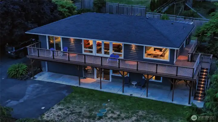 Trex deck with new foundation wraps two sides of the home. Custom metering and stairway/framing lighting complements the natural beauty before and around you.