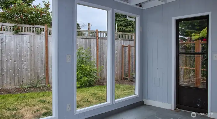 This covered enclosed patio has water and a drain for multiple uses. It is not heated at present.