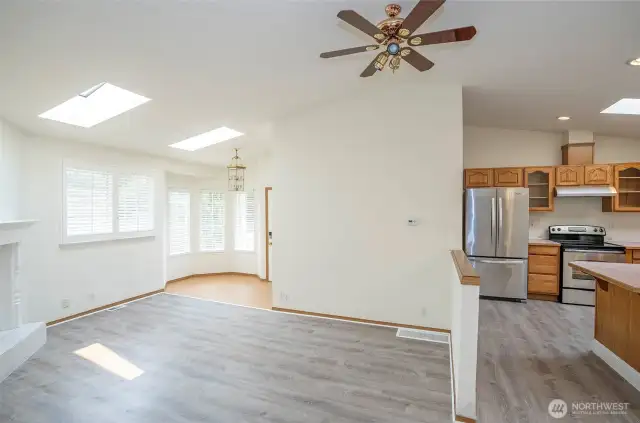 Open sightlines from the dining area to the living room, with kitchen just off to the right.