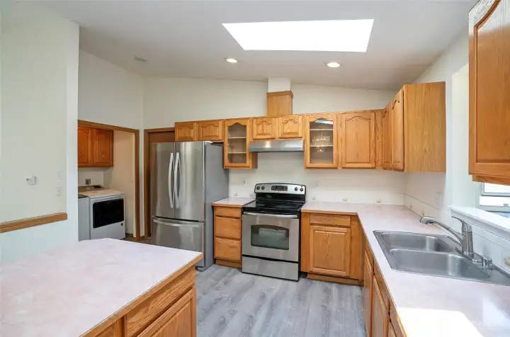 Plenty of gorgeous cabinets in the kitchen, with a utility room nearby offering even more.