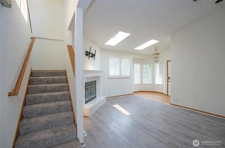Stairway opens to the upper level, showcasing the home’s light-filled design.