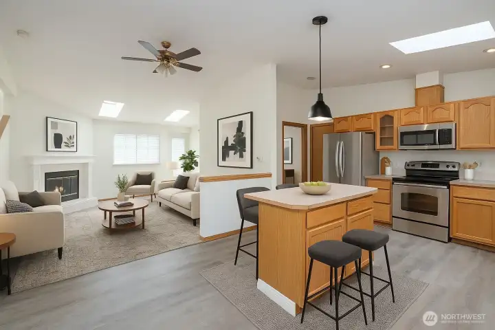 Skylights flood the open layout—dining area connects beautifully to the kitchen and living room - Virtual Staged