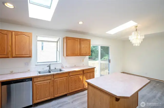 Open sightline from kitchen to dining area, with sliding door leading to the backyard.