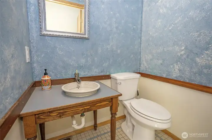 Main level powder room adds convenience for visitors.