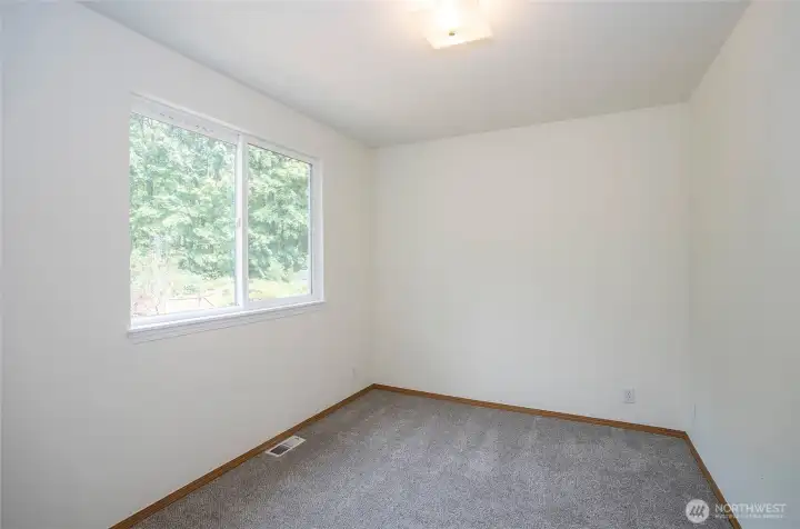 Bright main-floor den/office with oversized window.