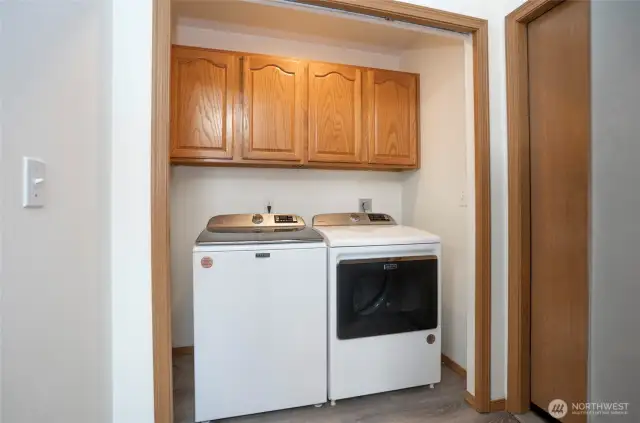 Convenient main-level utility room featuring added cabinetry.