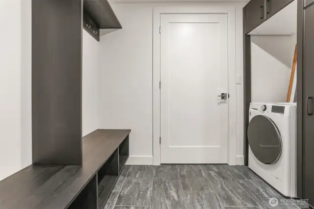 Convenient lower level mudroom offers another laundry.