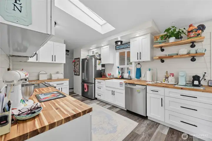 Bright and welcoming space connected to the back porch & utility room.
