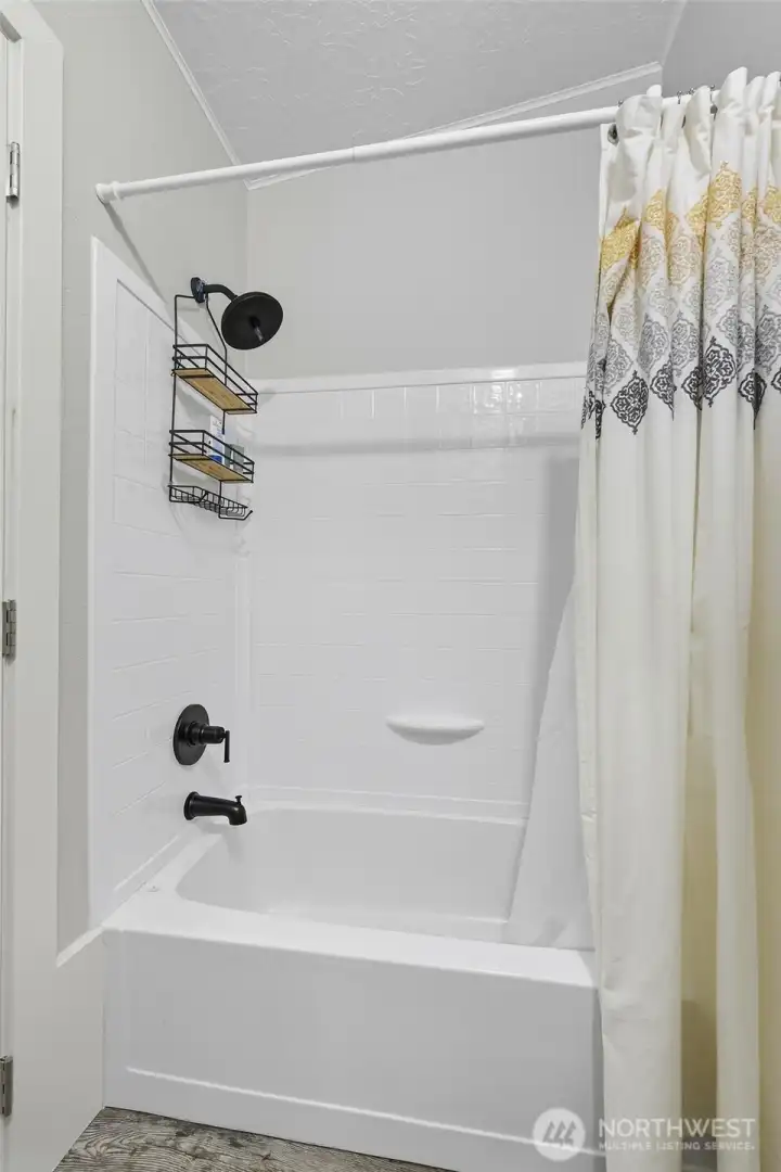 Sink on one side and full bath tub/shower on the other.