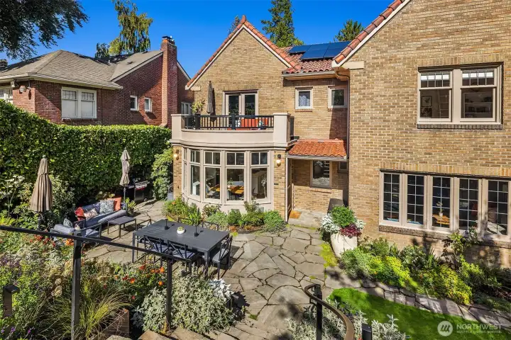 Entertain in style on the stone patio, surrounded by a professionally landscaped yard and a custom-built railing crafted by a Whidbey Island artist.