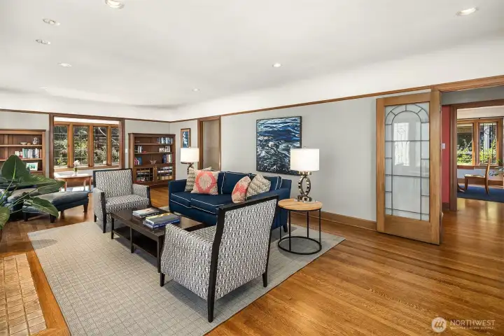 Leaded-glass French doors frame the space, accentuated by rich wood trim.